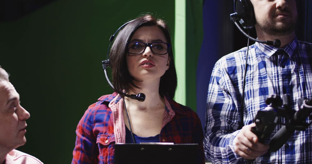 Associate producer wearing headphones on set