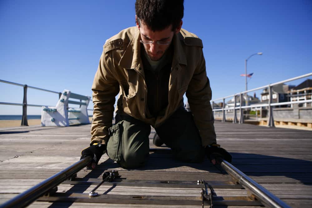 Dolly grip laying track on set