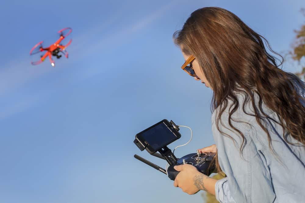 Drone Operator piloting her drone through the sky