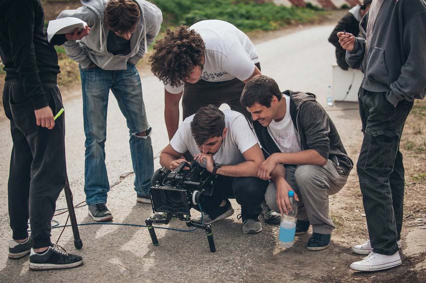 Director and team looking at camera on set