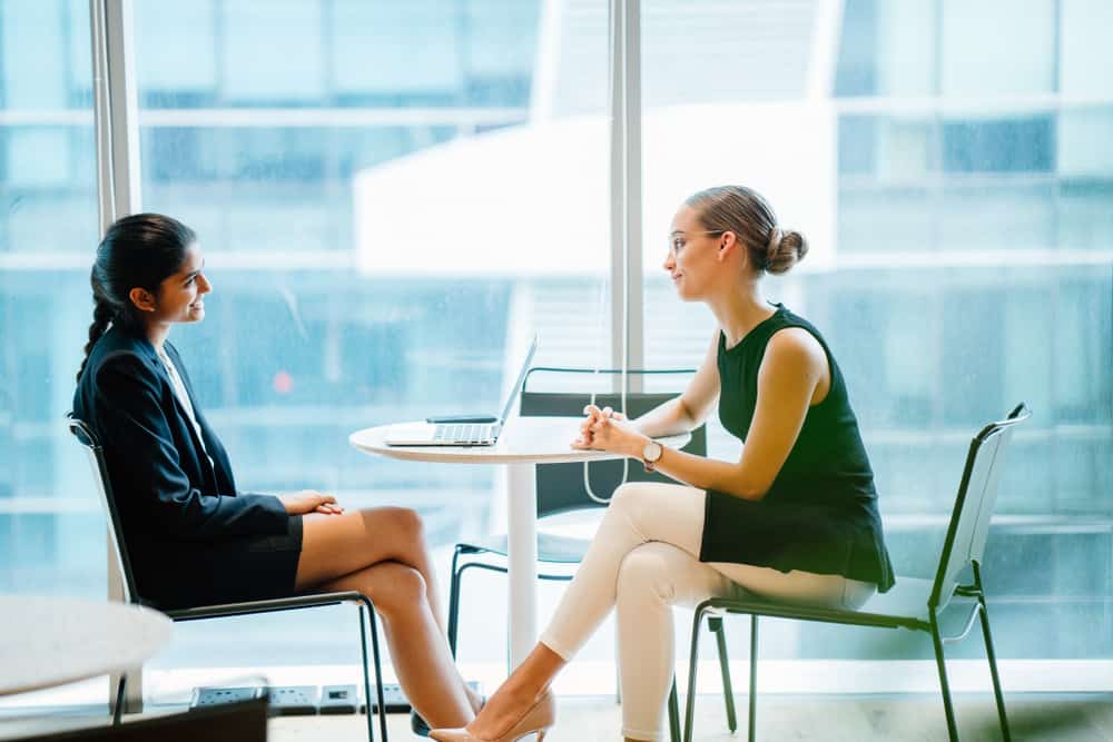 HR employee looking at film resume on her laptop as she interviews potential hire