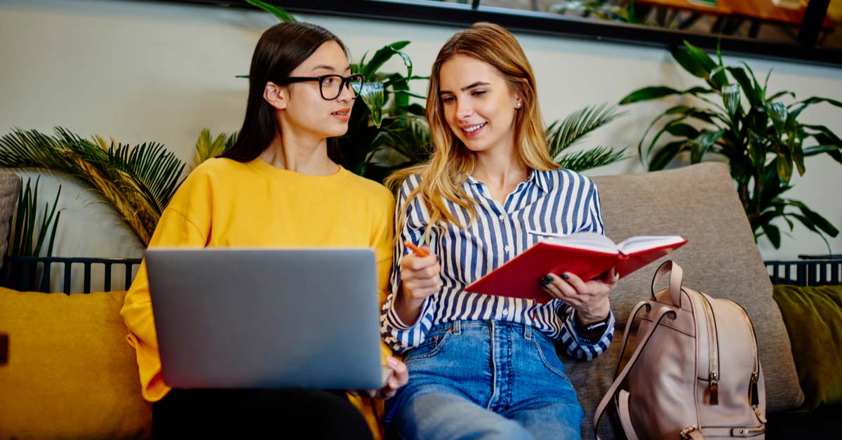 Two young women writing a screenplay