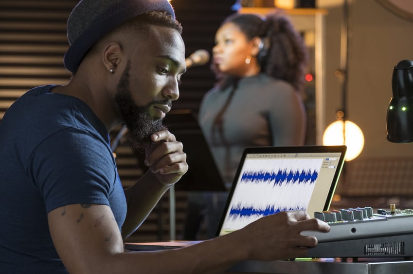 Music Supervisor in studio with session singer recording vocals