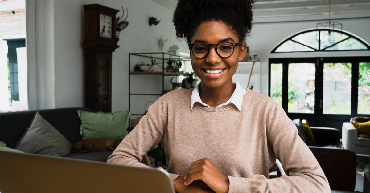 Black female Screenwriter writing at home