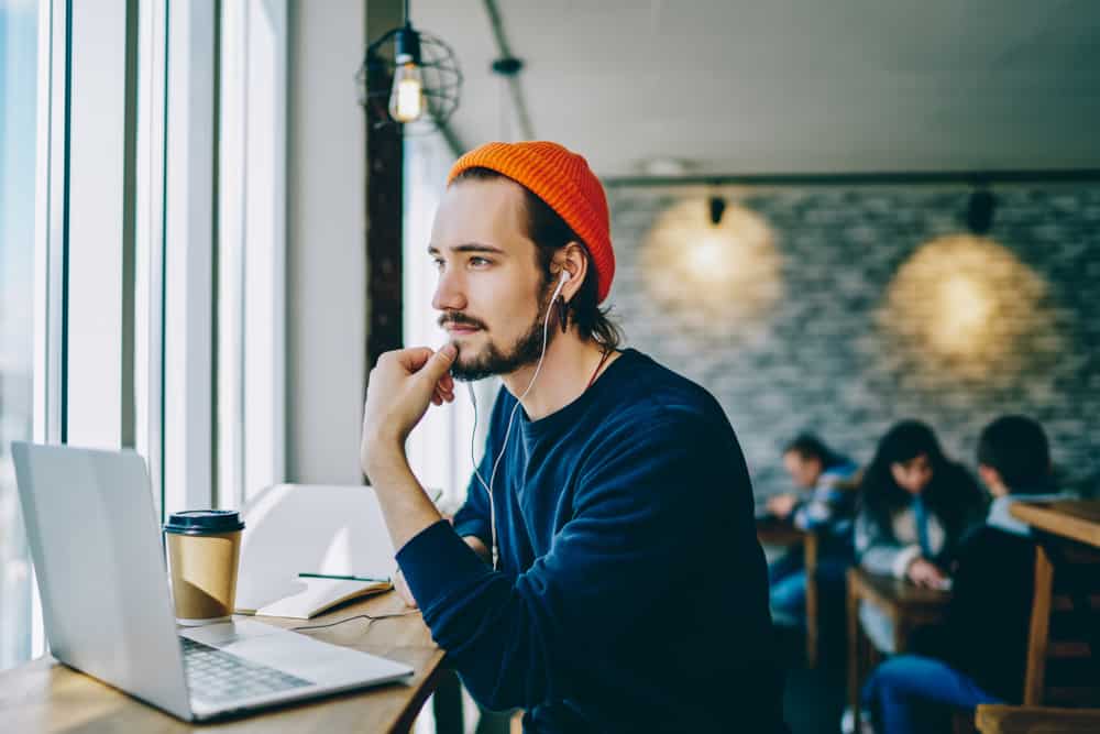 Screenwriter using the script template on his laptop in a cafe