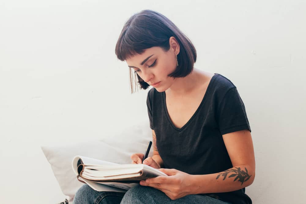 Brunette actress making notes on a script about stanislavski method