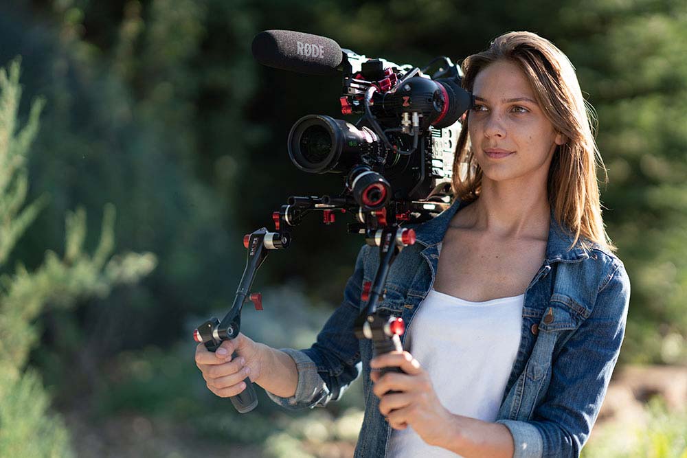 Female camera operator on outdoor shoot