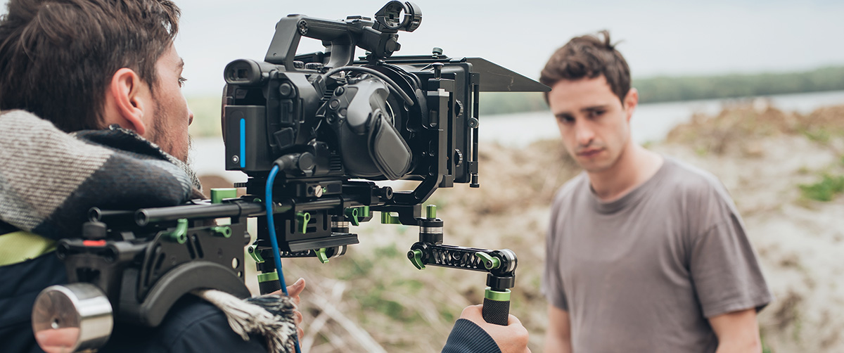 An actor stands in front of a camera.